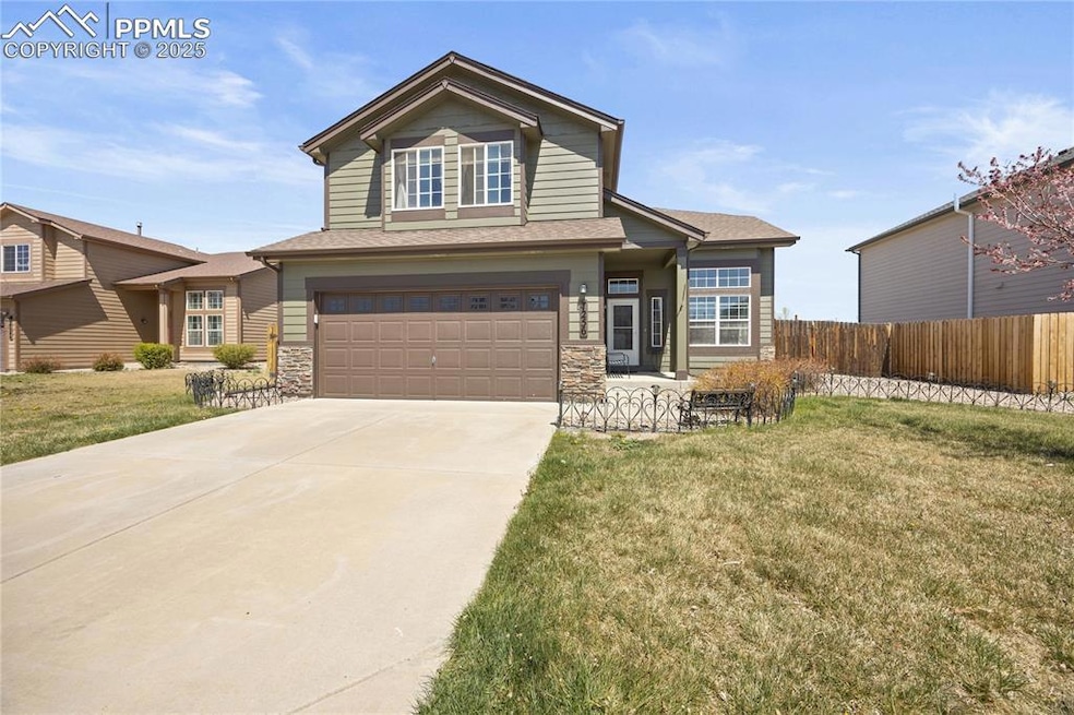 Traditional home featuring a garage, driveway, sto