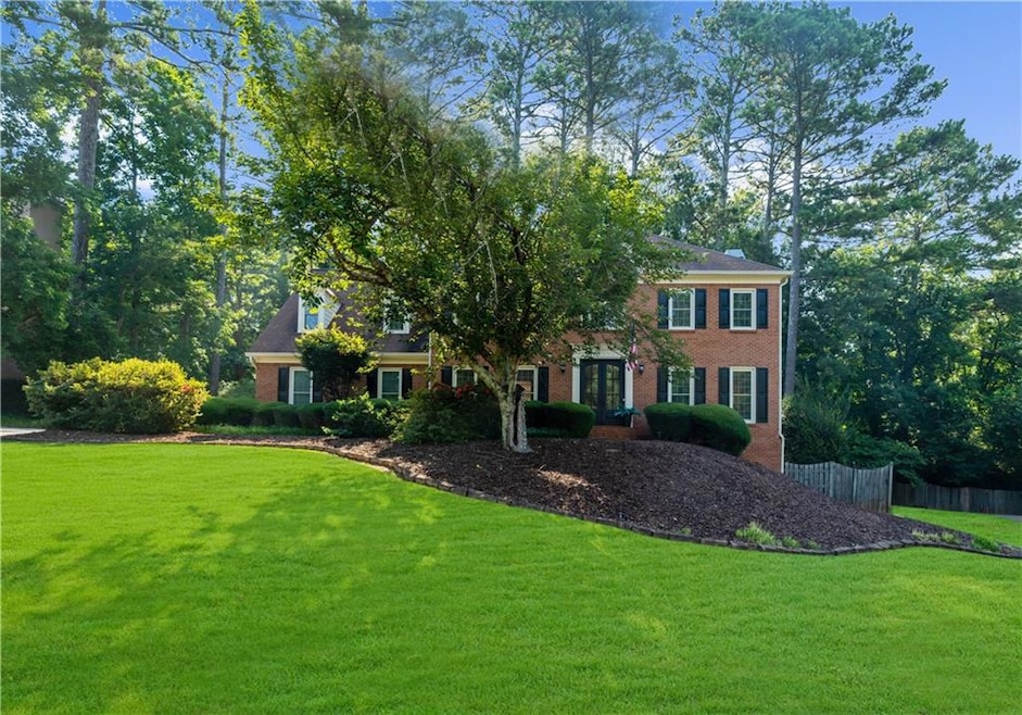 Stately brick-front home with NEW double front doors and beautiful curb appeal in desirable Parsons Run.