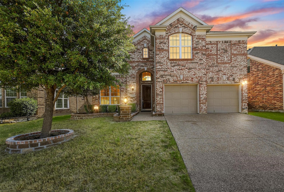View of front of house featuring a garage and a ya