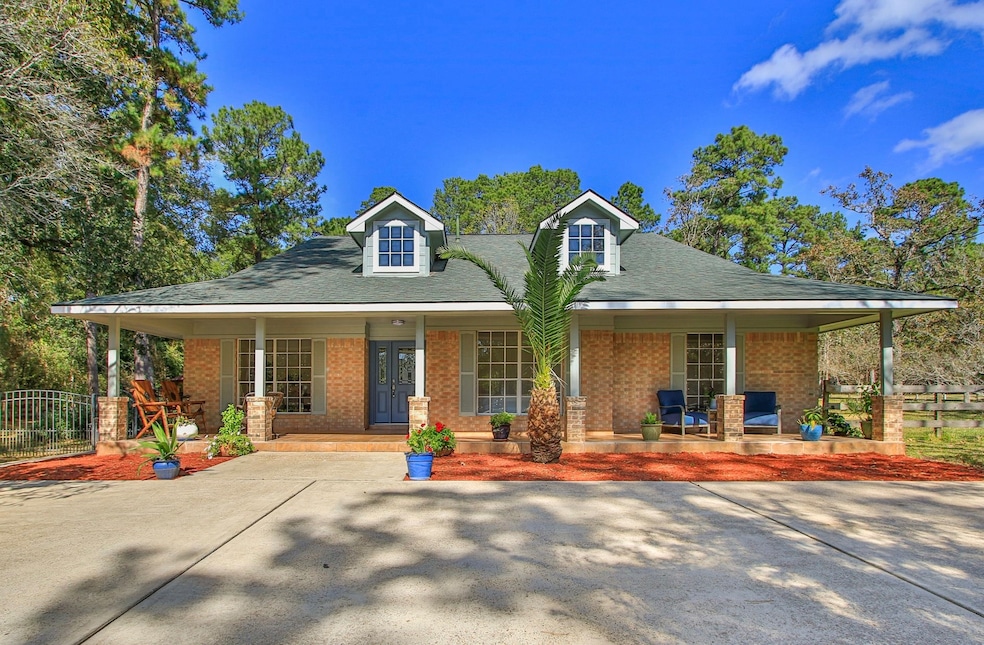 Charming brick home with a front porch that extends the length of the home.