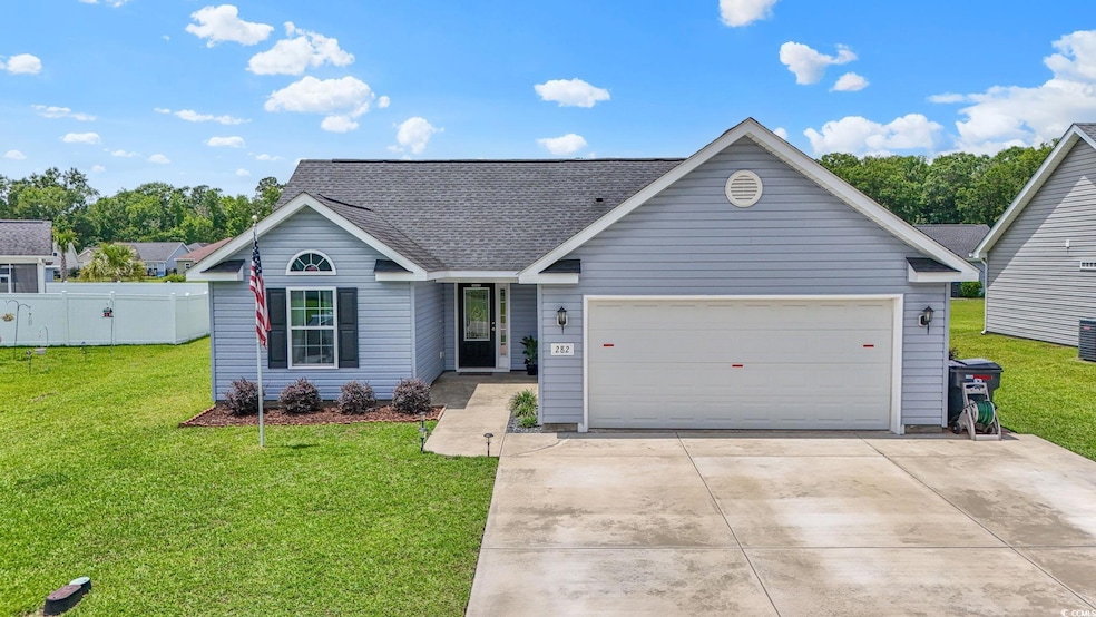 View of front of house with a garage, driveway, and a shingled roof