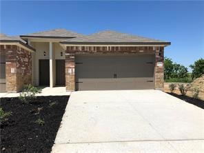 View of front of house featuring concrete driveway and an attached garage
