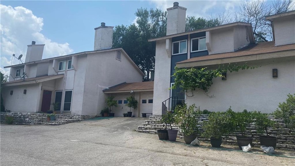 Back of house with a chimney, asphalt driveway, s