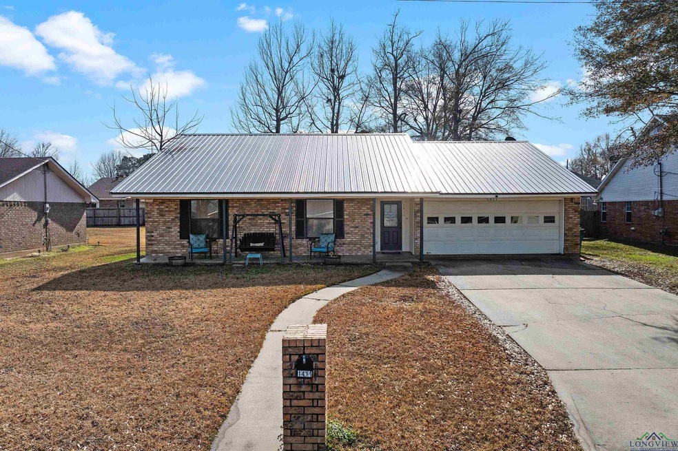 Ranch-style house featuring a porch and a garage