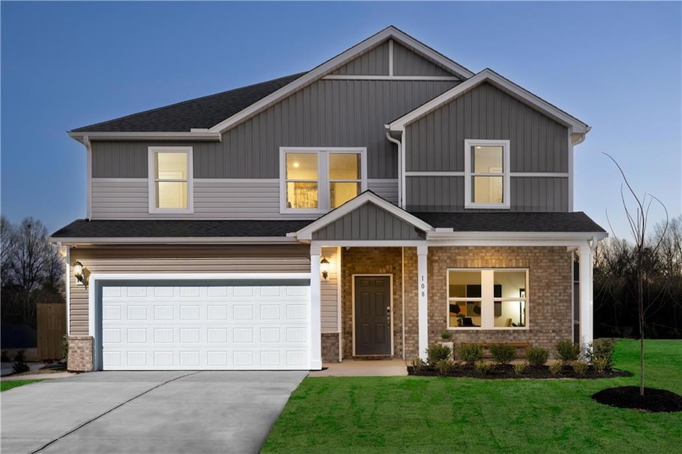 View of front of property with driveway, a garage,