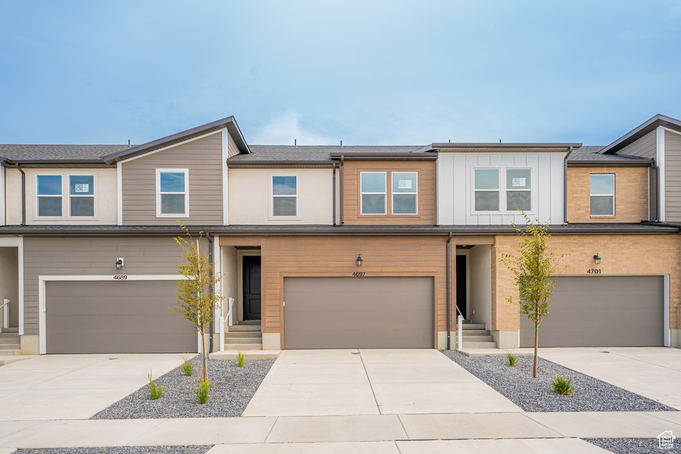 View of front of home featuring driveway and board and batten siding
