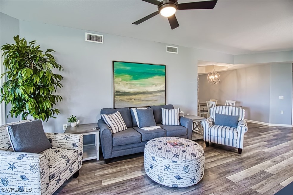Living area featuring ceiling fan with notable cha