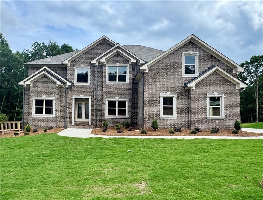 Craftsman inspired home with brick siding, a front lawn, and french doors