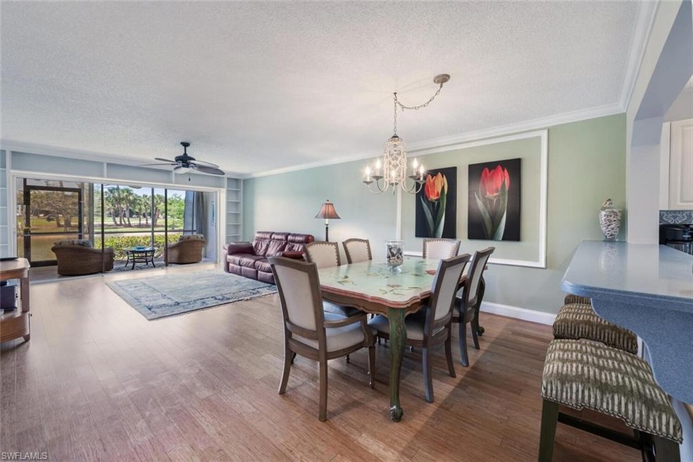 Dining room with baseboards, a textured ceiling, w