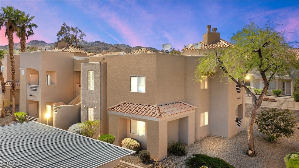 View of front of house with stucco siding and a tiled roof