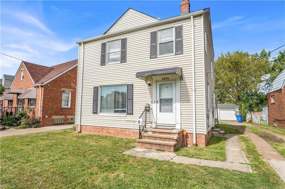 View of front of property with a front yard and a garage