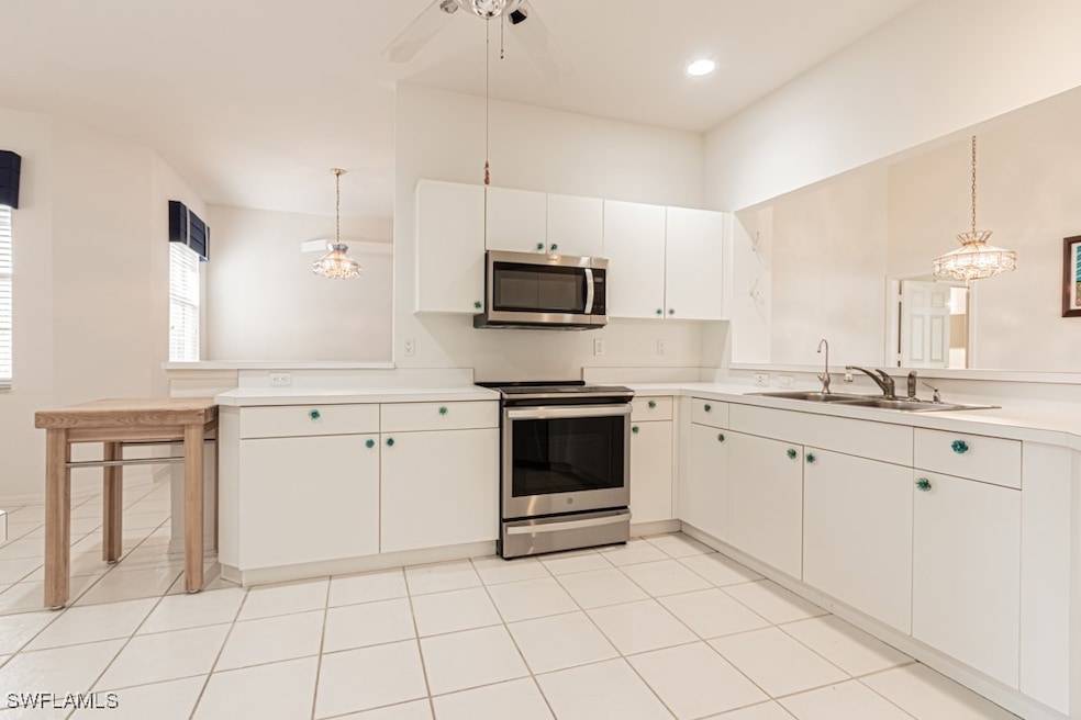 Kitchen featuring light countertops, a peninsula,