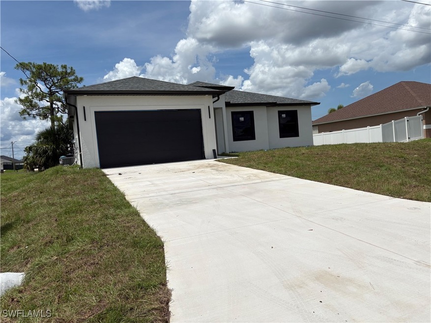 View of front of property with a garage, driveway,