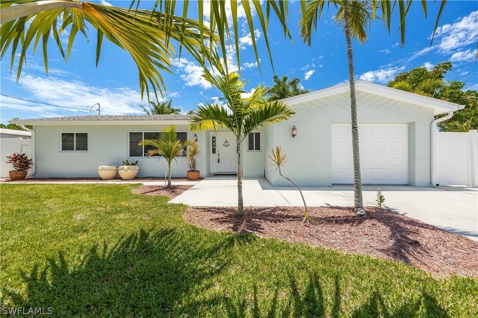Ranch-style house with a garage and a front lawn