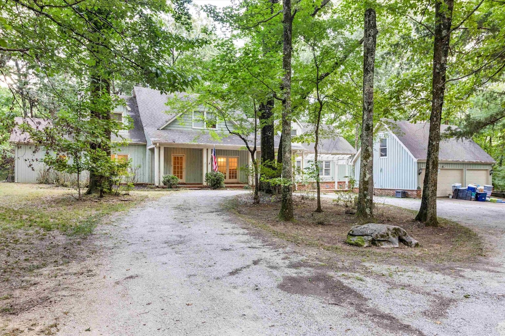 View of front of house featuring gravel driveway and covered porch