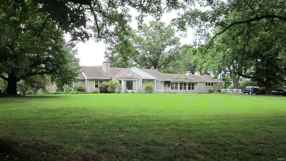 Large stone ranch on a magnificent 3.2 acre lot in the heart of Town & Country.