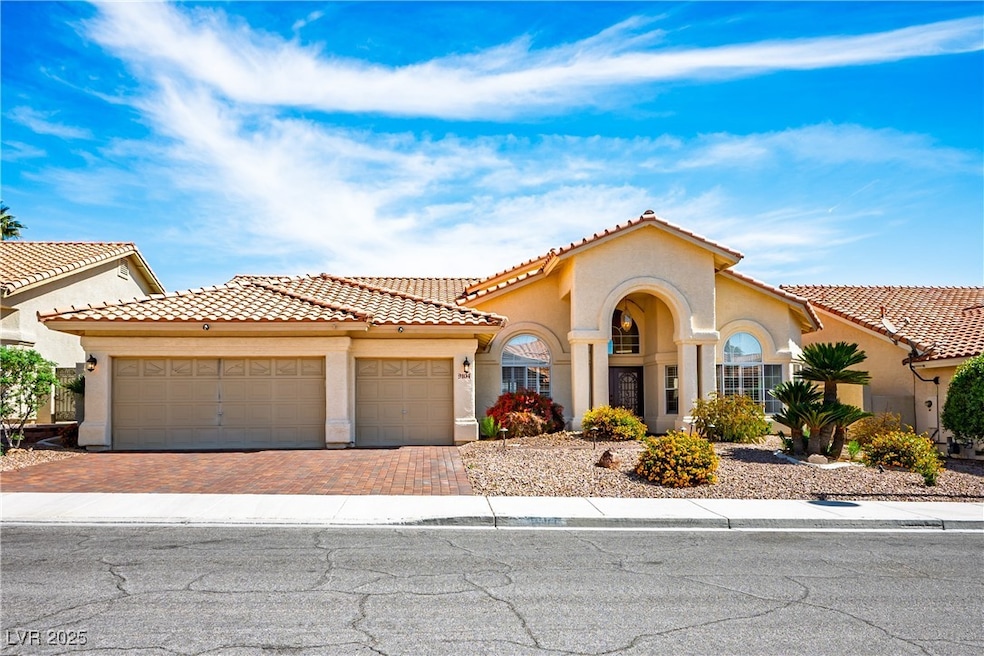 Mediterranean / spanish-style house featuring a ga