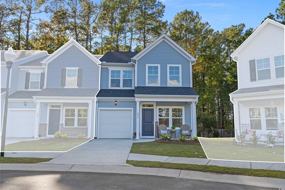 Traditional-style home featuring driveway, a shingled roof, an attached garage, and a front lawn
