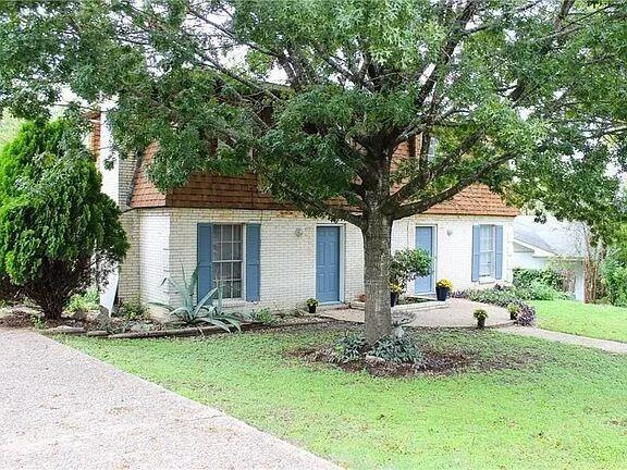 View of front of home with brick siding and a fro