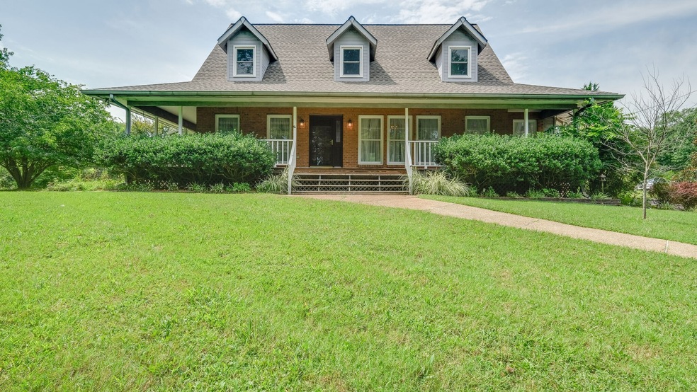Rocking chair front porch Cape Cod with windows galore for a fresh airy country feel on five wonderful private acres.