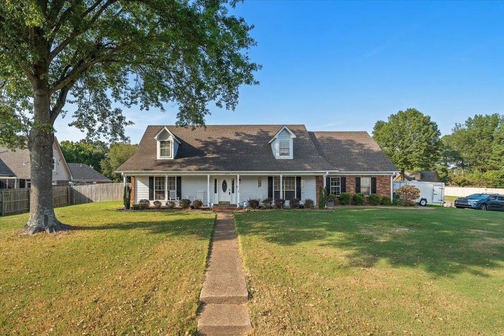 New england style home featuring a porch and brick siding