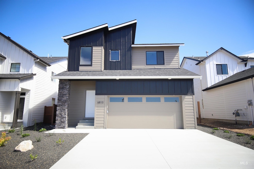 View of front of home with board and batten siding, a shingled roof, and an attached garage