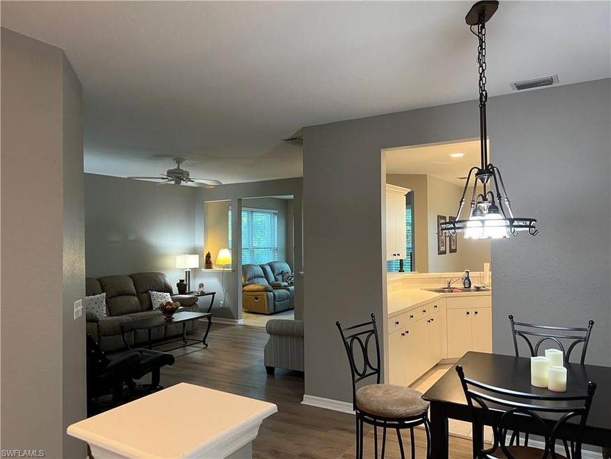 Dining space featuring visible vents, dark wood fi