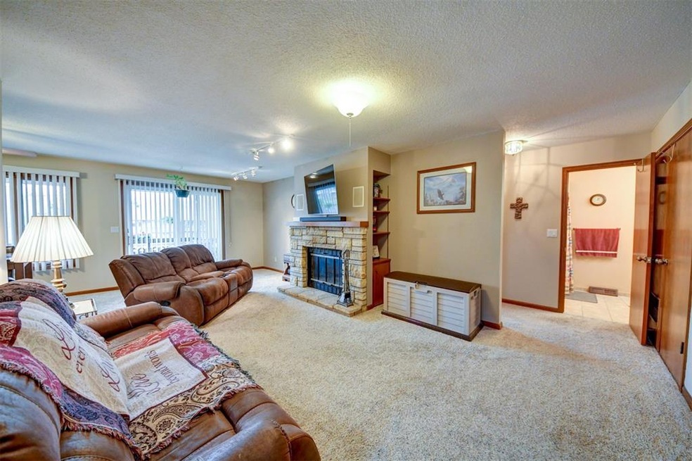 Spacious living room with stone, wood burning fire