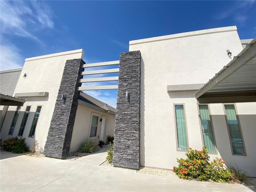 View of property exterior with stucco siding and stone siding