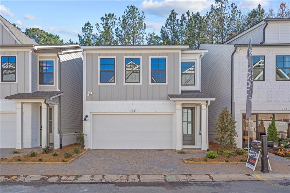 Townhome / multi-family property featuring a garag