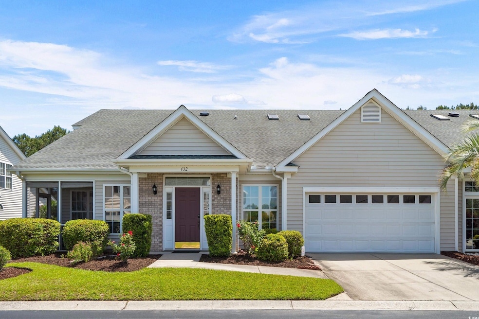 Multi unit property featuring concrete driveway, a