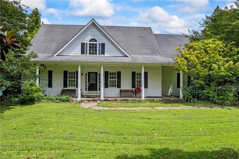View of front of home with a front yard and a porch