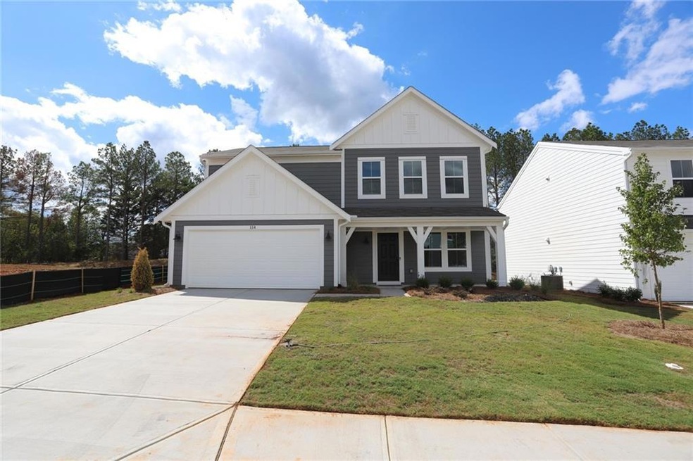 View of front of home featuring a garage and a front lawn