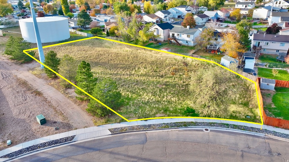 Aerial view of residential area featuring property boundaries highlighted