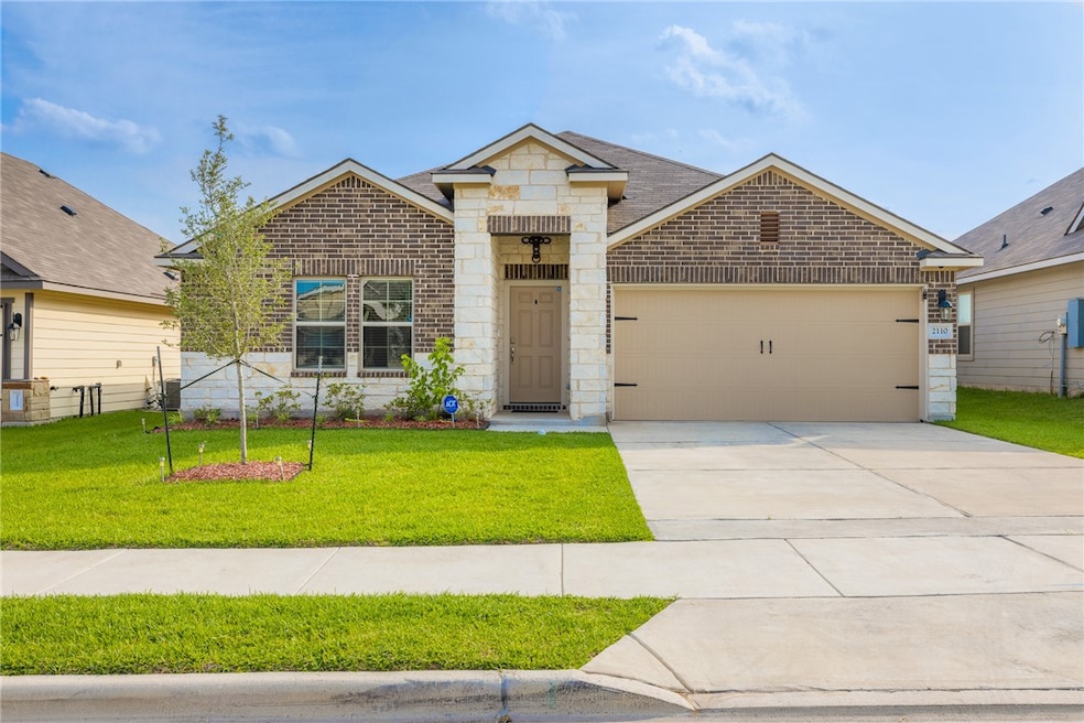 View of front of home featuring brick siding, a fr