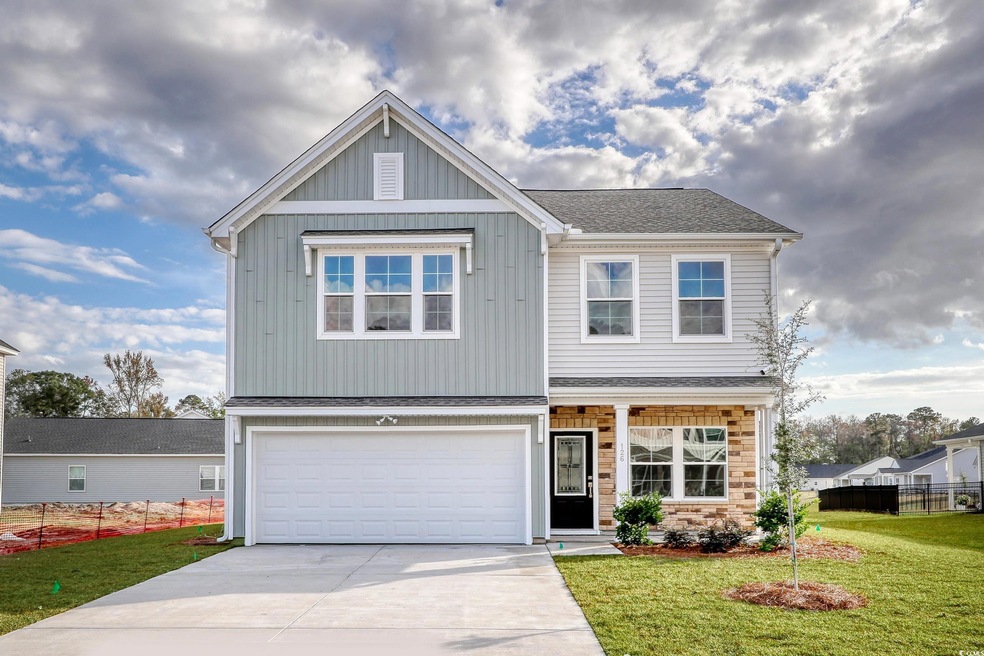 View of front of property with fence, a garage, a 