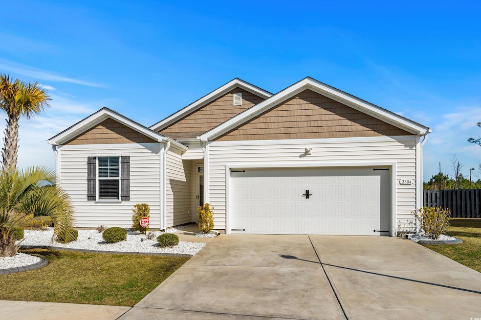 View of front facade featuring an attached garage and driveway