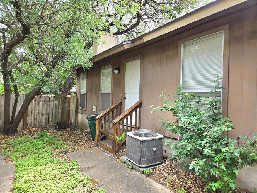 Doorway to property with fence and cooling unit