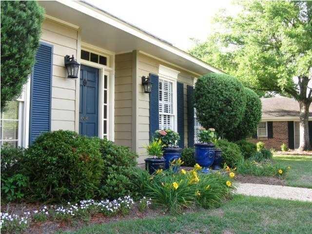 Fresh new paint and manicured flowerbeds along wit