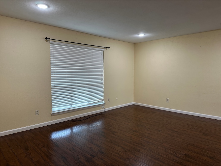 Unfurnished room with dark wood finished floors and recessed lighting