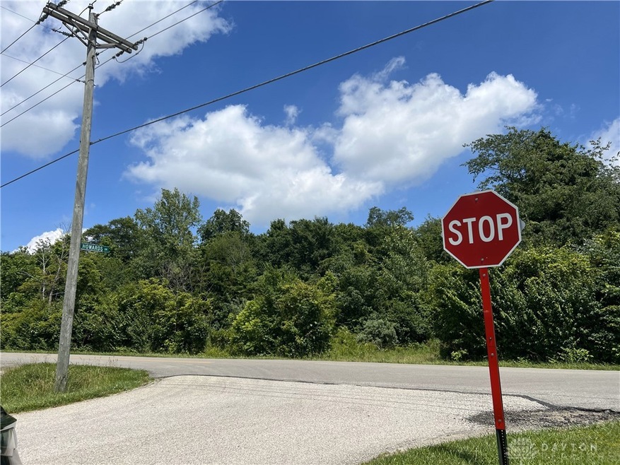 Entrance to Land is across the road from the stop sign near the listing sign.