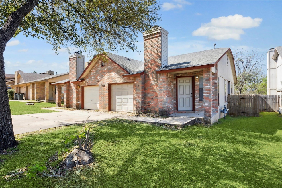 View of front of property featuring fence, a chim
