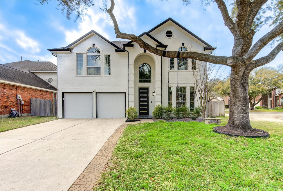 This photo shows a modern two-story home with a wh