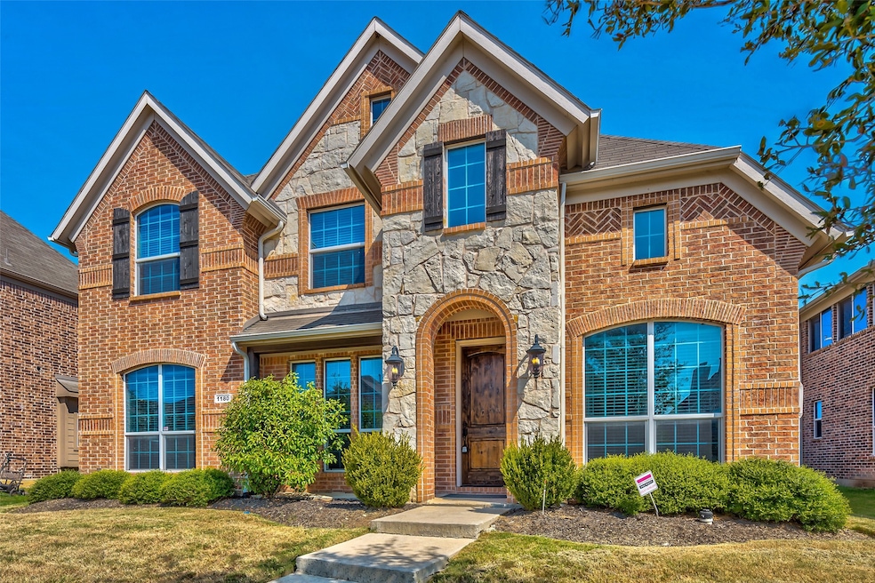 View of front of house featuring stone siding and brick siding