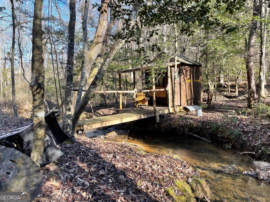 View of yard featuring a camping shed and bridge a