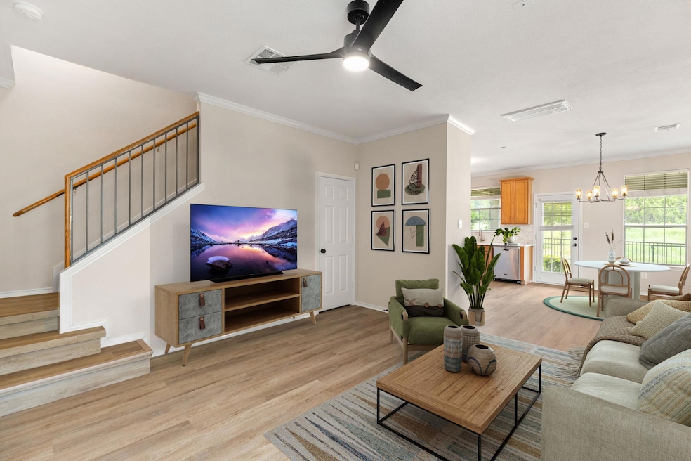 Living area featuring ceiling fan with notable ch