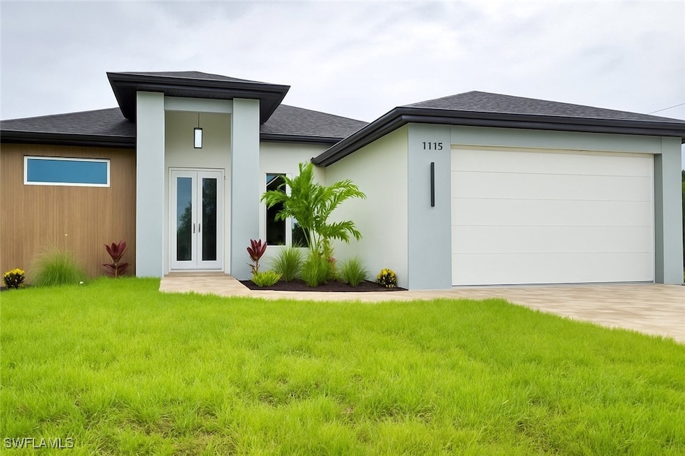 Rear view of house with french doors, a yard, an a
