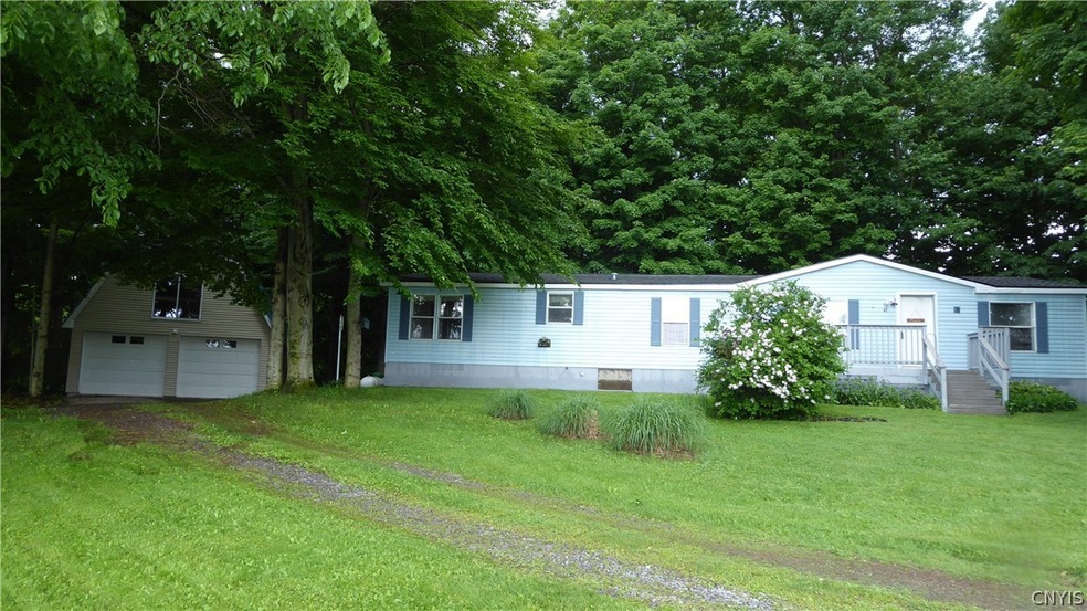 Front view  with deck and 2 car garage  with upsta