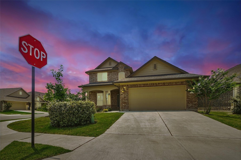 Traditional-style home featuring concrete drivewa