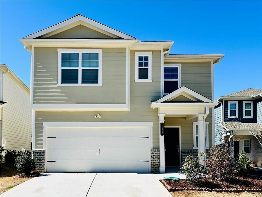 View of front facade featuring a garage and driveway